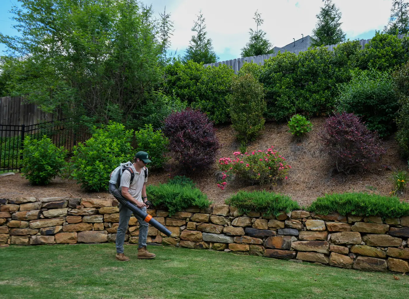 Blowing clippings and debris off the lawn after service