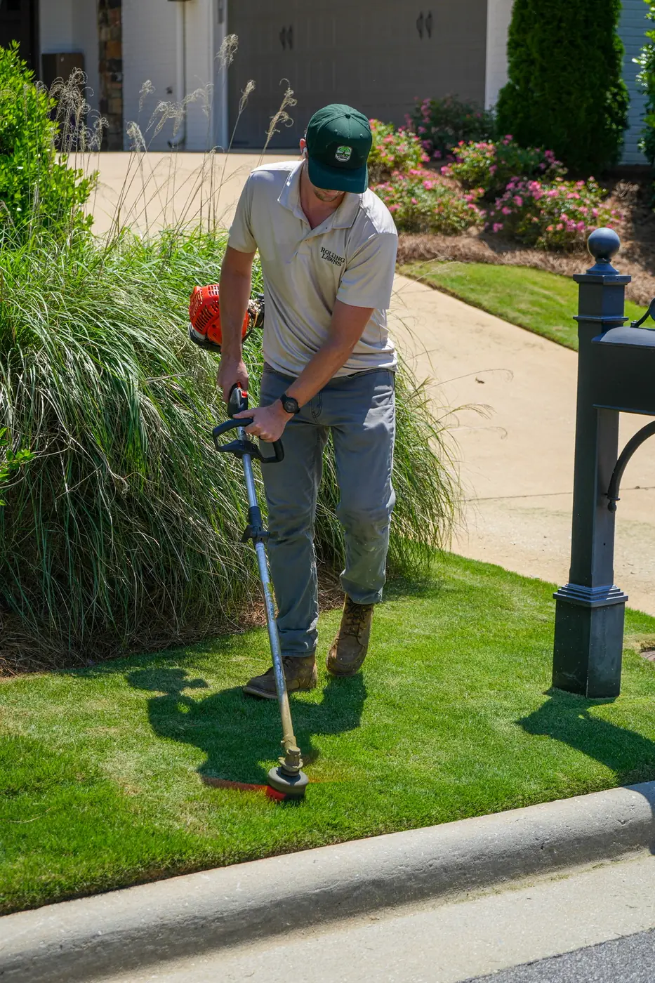 Detailed edging beside a driveway and ornamental grasses